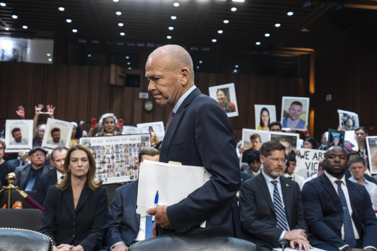 FILE - With protesters in the audience, Boeing CEO Dave Calhoun arrives at a Senate subcommittee hearing to answer to lawmakers about troubles at the aircraft manufacturer. Ike Riffel , a California father whose two sons, died in 2019 when a Boeing 737 Max jetliner crashed in Ethiopia, fears that instead of putting Boeing on trial, the government will offer the company another shot at corporate probation through a legal document called a deferred prosecution agreement, or DPA. (AP Photo/J.