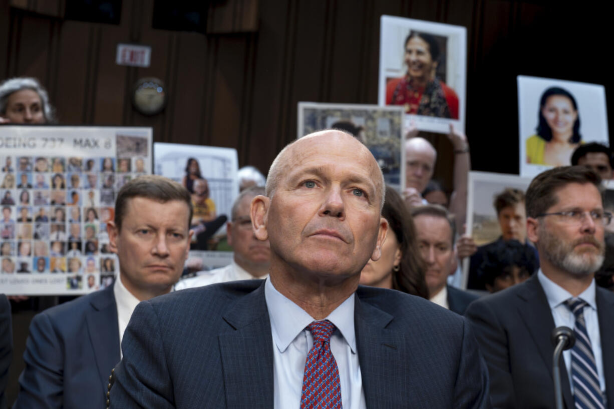 FILE - With protesters in the audience, Boeing CEO Dave Calhoun waits to testify before the Senate Homeland Security and Governmental Affairs Subcommittee on Investigations at the Capitol in Washington, Tuesday, June 18, 2024. On Sunday, July 7, 2024, the Justice Department said Boeing has agreed to plead guilty to a criminal fraud charge stemming from two deadly crashes of 737 Max jetliners.(AP Photo/J.