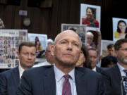 FILE - With protesters in the audience, Boeing CEO Dave Calhoun waits to testify before the Senate Homeland Security and Governmental Affairs Subcommittee on Investigations at the Capitol in Washington, Tuesday, June 18, 2024. On Sunday, July 7, 2024, the Justice Department said Boeing has agreed to plead guilty to a criminal fraud charge stemming from two deadly crashes of 737 Max jetliners.(AP Photo/J.