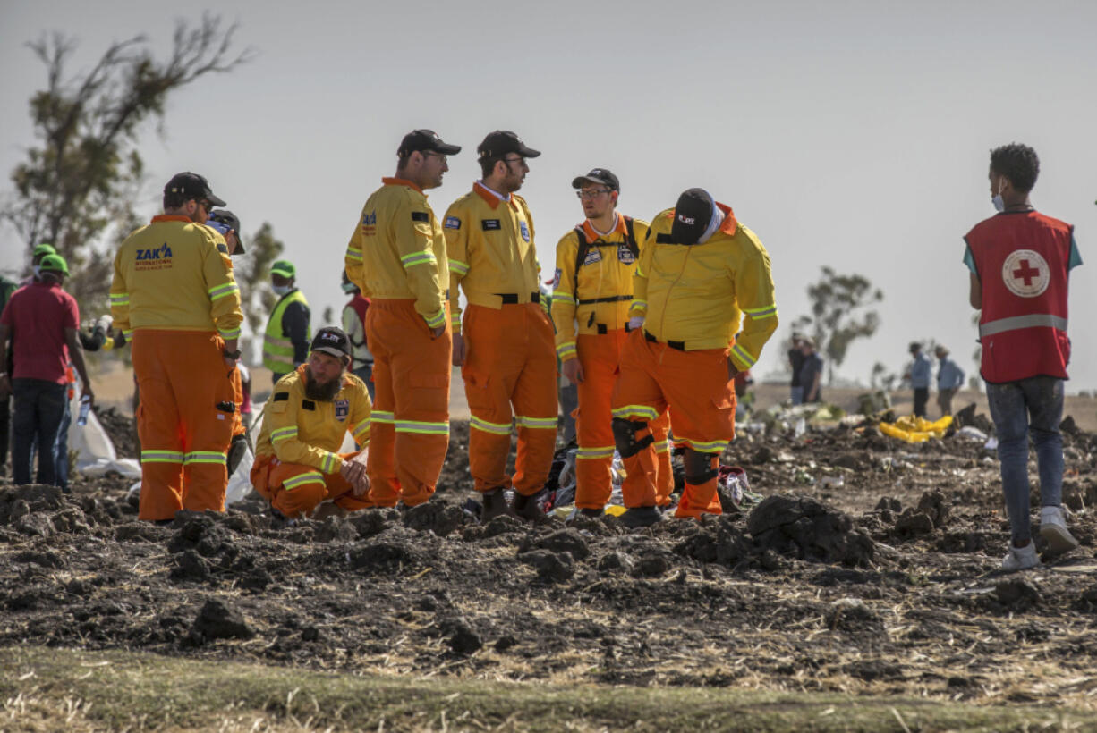 FILE - Investigators from Israel examine wreckage on March 12, 2019 at the scene of the Ethiopian Airlines Boeing 737 Max 8 crash near Bishoftu, or Debre Zeit, south of Addis Ababa, in Ethiopia. Families of people killed in the 737 Max crashes formally asked a federal judge in Texas to reject Boeing&#039;s plea deal with the Justice Department.