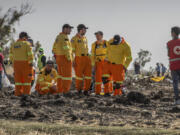 FILE - Investigators from Israel examine wreckage on March 12, 2019 at the scene of the Ethiopian Airlines Boeing 737 Max 8 crash near Bishoftu, or Debre Zeit, south of Addis Ababa, in Ethiopia. Families of people killed in the 737 Max crashes formally asked a federal judge in Texas to reject Boeing&#039;s plea deal with the Justice Department.