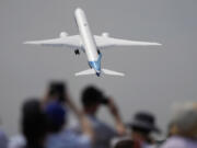FILE - A Boeing 777X plane takes off at the Farnborough Air Show fair in Farnborough, England, on July 18, 2022. An ongoing safety and manufacturing crisis has Boeing keeping a lower profile at the 2024 Farnborough International Air Show, which kicks off Monday in England.