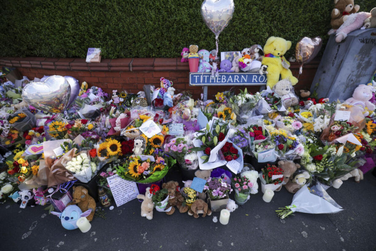 Flowers and toys are placed on the junction of Tithebarn Road and Hart Street in Southport, England, Wednesday, July 31, 2024, after three girls killed in a knife attack at a Taylor Swift-themed holiday club on Monday.