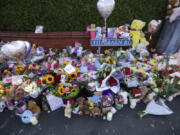 Flowers and toys are placed on the junction of Tithebarn Road and Hart Street in Southport, England, Wednesday, July 31, 2024, after three girls killed in a knife attack at a Taylor Swift-themed holiday club on Monday.