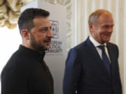 Poland&rsquo;s Prime Minister Donald Tusk, right, stands next to Ukrainian President Volodymyr Zelenskyy, during the European Political Community meeting, near Oxford, England, Thursday July 18, 2024.