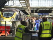 Passengers arrive by train at the Eurostar terminal at St. Pancras station in central London, Friday July 26, 2024. Hours away from the grand opening ceremony of the Olympics, high-speed rail traffic to the French capital was severely disrupted on Friday by what officials described as &ldquo;criminal actions&rdquo; and sabotage.