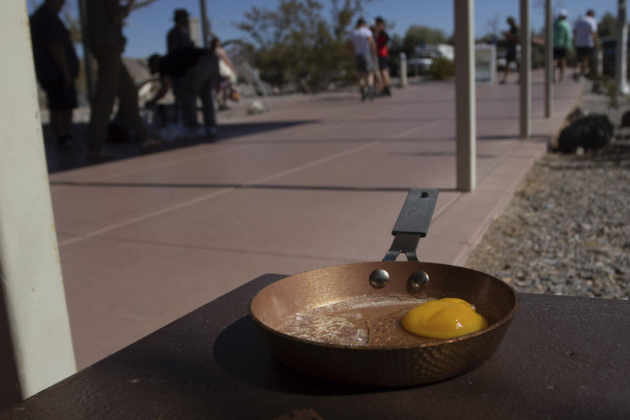 An egg lays in a small frying pan at the Furnace Creek Visitors Center in Death Valley National Park, Calif., Sunday, July 7, 2024. Forecasters say a heat wave could break previous records across the U.S., including in Death Valley.