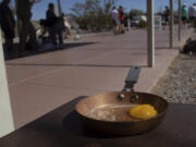 An egg lays in a small frying pan at the Furnace Creek Visitors Center in Death Valley National Park, Calif., Sunday, July 7, 2024. Forecasters say a heat wave could break previous records across the U.S., including in Death Valley.