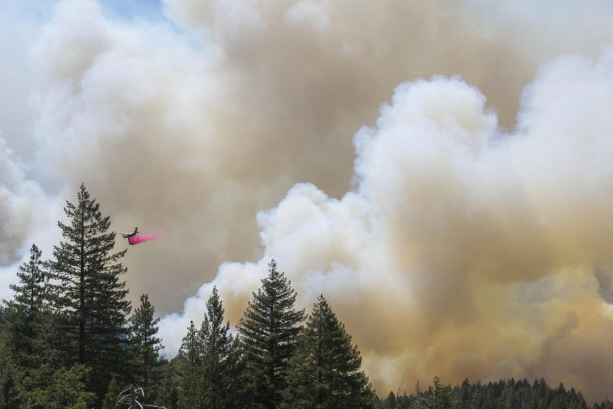 A plane drops fire retardant on the Park Fire near Forest Ranch, Calif., Sunday, July 28, 2024.