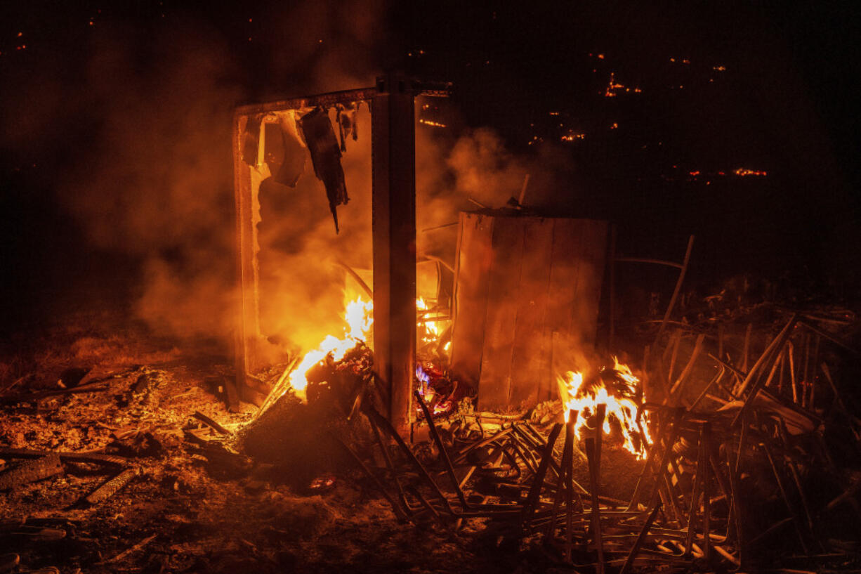 Flames from the French Fire consume a storage area at a athletic field in Mariposa, Calif., on Friday, July 5, 2024.