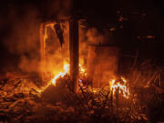 Flames from the French Fire consume a storage area at a athletic field in Mariposa, Calif., on Friday, July 5, 2024.