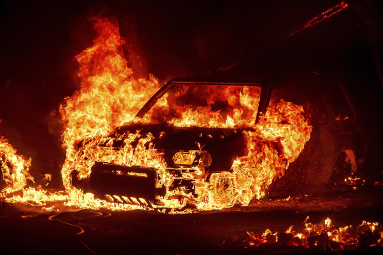 Flames consume a vehicle as the Park Fire jburns in Tehama County, Calif., on Friday, July 26, 2024.