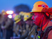 Fire crews monitor a burn operation along Highway 36 to slow the Park Fire near Dales, Calif., Monday, July 29, 2024.