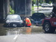 A tow truck operator responds to submerged vehicles at an underpass at Parkside Drive and Lake Shore Blvd., after heavy rain caused flooding, in Toronto on Tuesday, July 16, 2024.