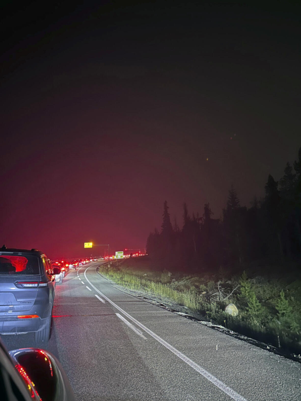 This photo provided by Carolyn Campbell shows cars clogging the highway as people evacuate because of wildfires early Tuesday, July 23, 2024, in Jasper, Alberta. Multiple wildfires in Canada&rsquo;s Jasper National Park have flared up, forcing all park visitors along with the 4,700 residents of the Jasper townsite to flee.