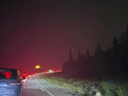 This photo provided by Carolyn Campbell shows cars clogging the highway as people evacuate because of wildfires early Tuesday, July 23, 2024, in Jasper, Alberta. Multiple wildfires in Canada&rsquo;s Jasper National Park have flared up, forcing all park visitors along with the 4,700 residents of the Jasper townsite to flee.