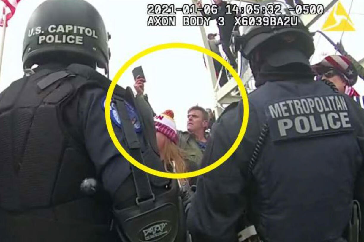 FILE - This image from Washington Metropolitan Police Department body-worn video, released and annotated by the Justice Department in the statement of facts supporting an arrest warrant for Jay James Johnston, shows Johnston, circled in yellow, at the U.S. Capitol on Jan. 6, 2021, in Washington. Johnston, an actor known for comedic roles in the movie &ldquo;Anchorman&rdquo; and the television series &ldquo;Bob&rsquo;s Burgers&rdquo; has pleaded guilty to interfering with police officers trying to protect the U.S. Capitol from a mob&rsquo;s attack. Johnston faces a maximum sentence of five years in prison after pleading guilty on Monday to a felony count of civil disorder.