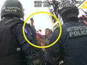 FILE - This image from Washington Metropolitan Police Department body-worn video, released and annotated by the Justice Department in the statement of facts supporting an arrest warrant for Jay James Johnston, shows Johnston, circled in yellow, at the U.S. Capitol on Jan. 6, 2021, in Washington. Johnston, an actor known for comedic roles in the movie &ldquo;Anchorman&rdquo; and the television series &ldquo;Bob&rsquo;s Burgers&rdquo; has pleaded guilty to interfering with police officers trying to protect the U.S. Capitol from a mob&rsquo;s attack. Johnston faces a maximum sentence of five years in prison after pleading guilty on Monday to a felony count of civil disorder.