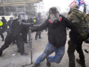 FILE - Insurrectionists loyal to President Donald Trump confront police as they storm the U.S. Capitol on Jan. 6, 2021, in Washington. Former President Donald Trump said during a debate with President Joe Biden last week that the Jan.