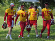 Kansas City Chiefs quarterbacks Carson Wentz (11), Chris Oladokun (13), Ian Book (2) and Patrick Mahomes (15) walk to practice at NFL football training camp Wednesday, July 17, 2024, in St. Joseph, Mo.