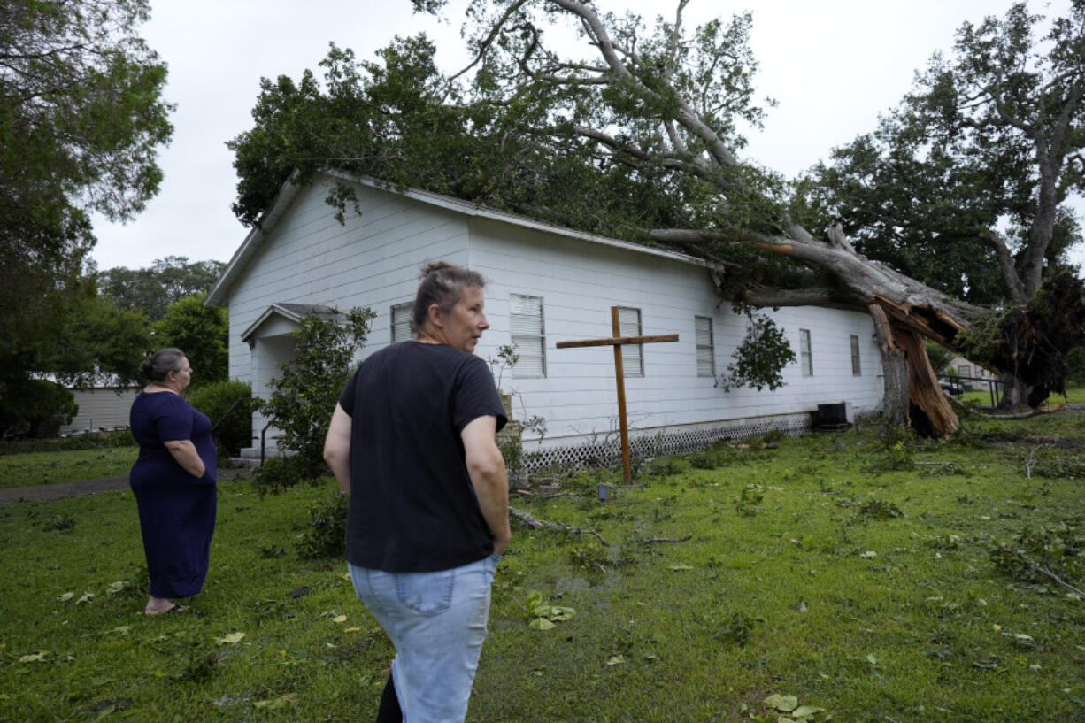 Ann McCauley, right, examines the damage at Bethel Church after Hurricane Beryl moved through the area July 8 in Van Vleck, Texas.