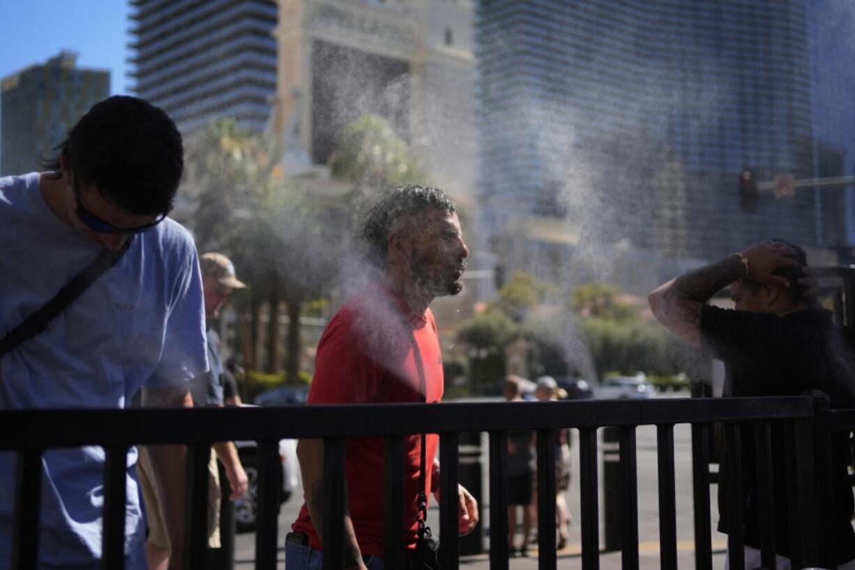 People cool off in misters along the Las Vegas Strip on July 7 in Las Vegas.