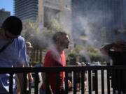 People cool off in misters along the Las Vegas Strip on July 7 in Las Vegas.
