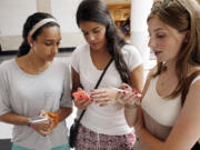 FILE &mdash; Isabella Cimato, 17, from left, Arianna Schaden, 14, and Sofia Harrison, 15, check their phones at Roosevelt Field shopping mall in Garden City, N.Y., on July 27, 2015. The last time Congress passed a law to protect children on the internet was in 1998, before Facebook, the iPhone and long before today&rsquo;s oldest teenagers were born. Now, a bill aiming to protect kids from the harms of social media, gaming sites and other online platforms appears to have enough bipartisan support to pass, though whether it actually will remains uncertain.