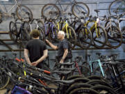 FILE - Customer Dan Inks, right, shops at University Bicycles in Boulder, Colo., on April 30, 2024. On Tuesday, July 30, 2024, the Conference Board reports on U.S. consumer confidence for July.