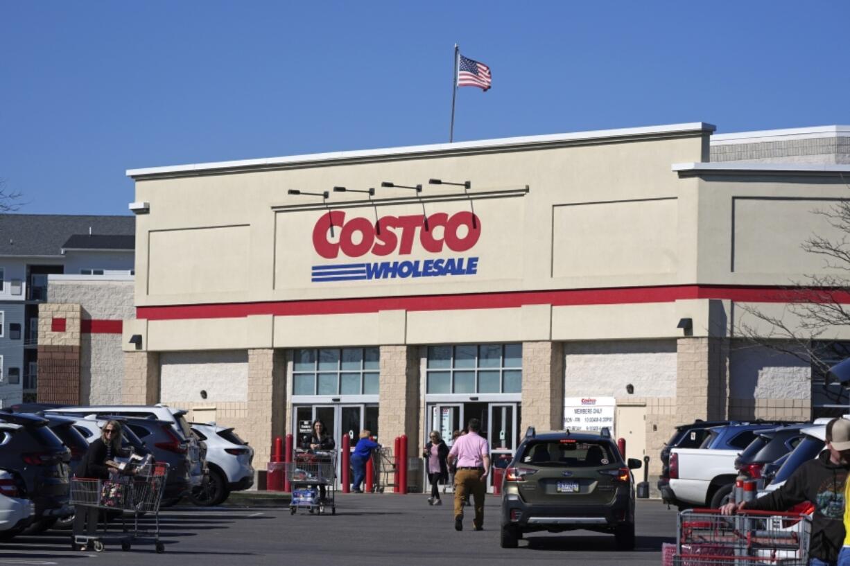 FILE - People enter Costco Warehouse in Cranberry Township, Pa., Friday, March 29, 2024. Costco bargain hunters are going to have to pay an additional $5 to $10 annually as the popular warehouse chain prepares to raise its membership fees for the first time in seven years. (AP Photo/Gene J.