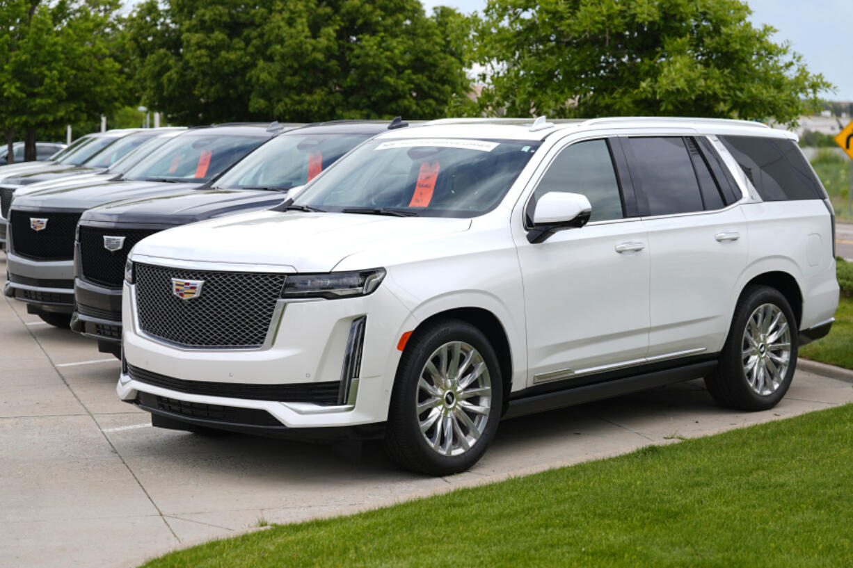 FILE - Unsold 2024 Escalade utility vehicles sit in a row outside a Cadillac dealership on June 2, 2024, in Lone Tree, Colo. General Motors reports earnings on Tuesday, July 23, 2024.