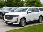 FILE - Unsold 2024 Escalade utility vehicles sit in a row outside a Cadillac dealership on June 2, 2024, in Lone Tree, Colo. General Motors reports earnings on Tuesday, July 23, 2024.