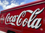 FILE - The Coca-Cola logo adorns the side of a delivery truck May 15, 2024, in southeast Denver. Coca-Cola reports earnings on Tuesday, July 23, 2024.