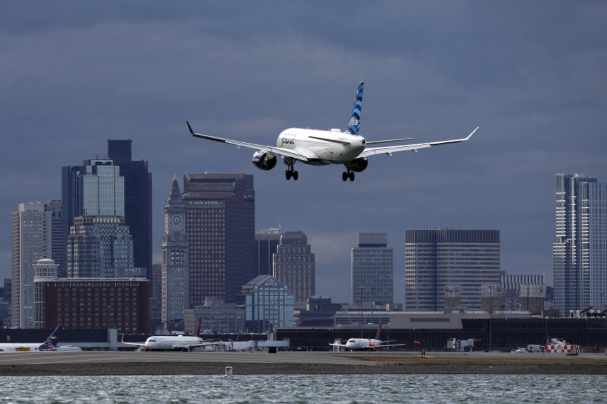 FILE - A JetBlue plane lands at Logan International Airport, Jan. 26, 2023, in Boston. JetBlue reports earnings on Tuesday, July 30, 2024.