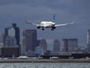 FILE - A JetBlue plane lands at Logan International Airport, Jan. 26, 2023, in Boston. JetBlue reports earnings on Tuesday, July 30, 2024.