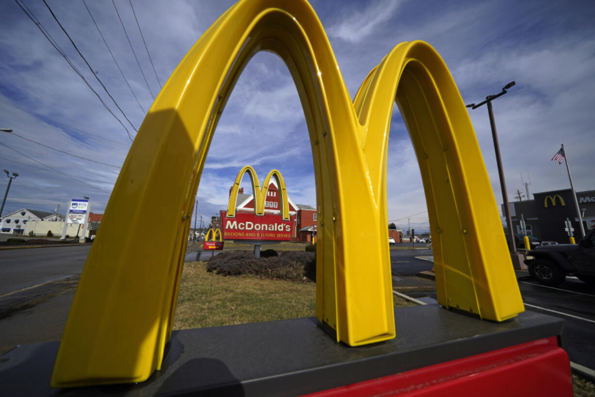 FILE - McDonald&rsquo;s restaurant signs are shown in in East Palestine, Ohio, Feb. 9, 2023. McDonald&rsquo;s reports earning on Monday, July 29, 2024.(AP Photo/Gene J.