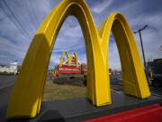 FILE - McDonald&rsquo;s restaurant signs are shown in in East Palestine, Ohio, Feb. 9, 2023. McDonald&rsquo;s reports earning on Monday, July 29, 2024.(AP Photo/Gene J.