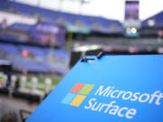 File - A Microsoft Surface logo is seen before an NFL football game between the Houston Texans and the Baltimore Ravens, on Jan. 20, 2024, in Baltimore. Microsoft reports earnings on Tuesday, July 30, 2024.