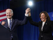 FILE - President Joe Biden and Vice President Kamala Harris stand on stage at the Democratic National Committee winter meeting, Feb. 3, 2023, in Philadelphia.