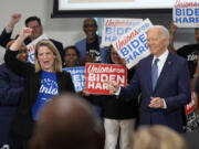 President Joe Biden arrives for a visit to AFL-CIO headquarters, Wednesday, July 10, 2024, in Washington, as AFL-CIO president Liz Shuler, left, cheers.