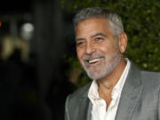 FILE - George Clooney, a cast member in &ldquo;Ticket to Paradise,&rdquo; poses at the premiere of the film, Monday, Oct. 17, 2022, at the Regency Village Theatre in Los Angeles. Just weeks after headlining a record-breaking fundraiser for the president&rsquo;s reelection campaign, Clooney wrote a New York Times opinion piece calling for Biden to end his bid.