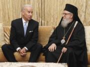 FILE - Vice President Joe Biden poses for photos with Archbishop Demetrios, the Primate of the Greek Orthodox Church in America, at the beginning of their meeting, in New York, Nov. 16, 2011. Historians and political advisers say history will be kinder to President Joe Biden than voters have been. Biden dropped out of the presidential race Sunday, July 21, 2024, clearing the way for a new Democratic nominee.