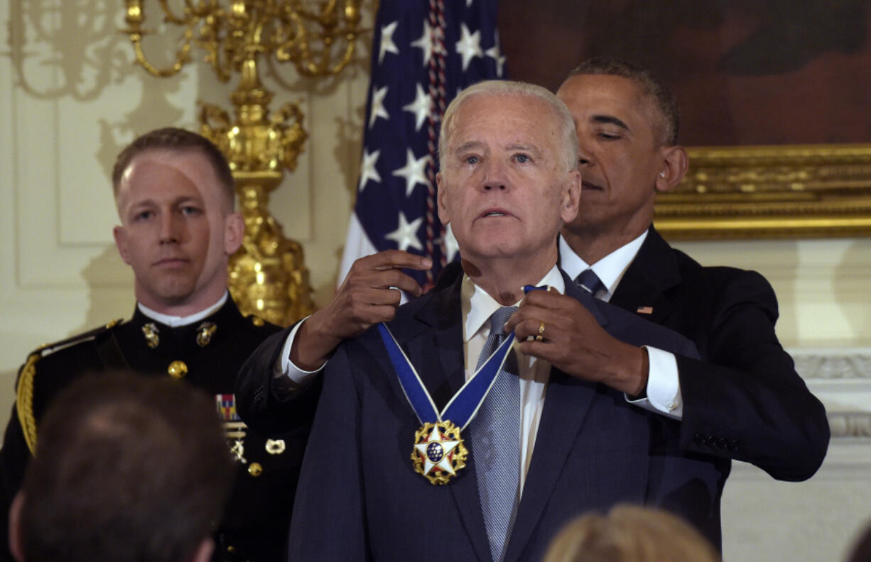 President Barack Obama presents Vice President Joe Biden with the Presidential Medal of Freedom during a ceremony in the State Dining Room of the White House in Washington, Jan. 12, 2017.