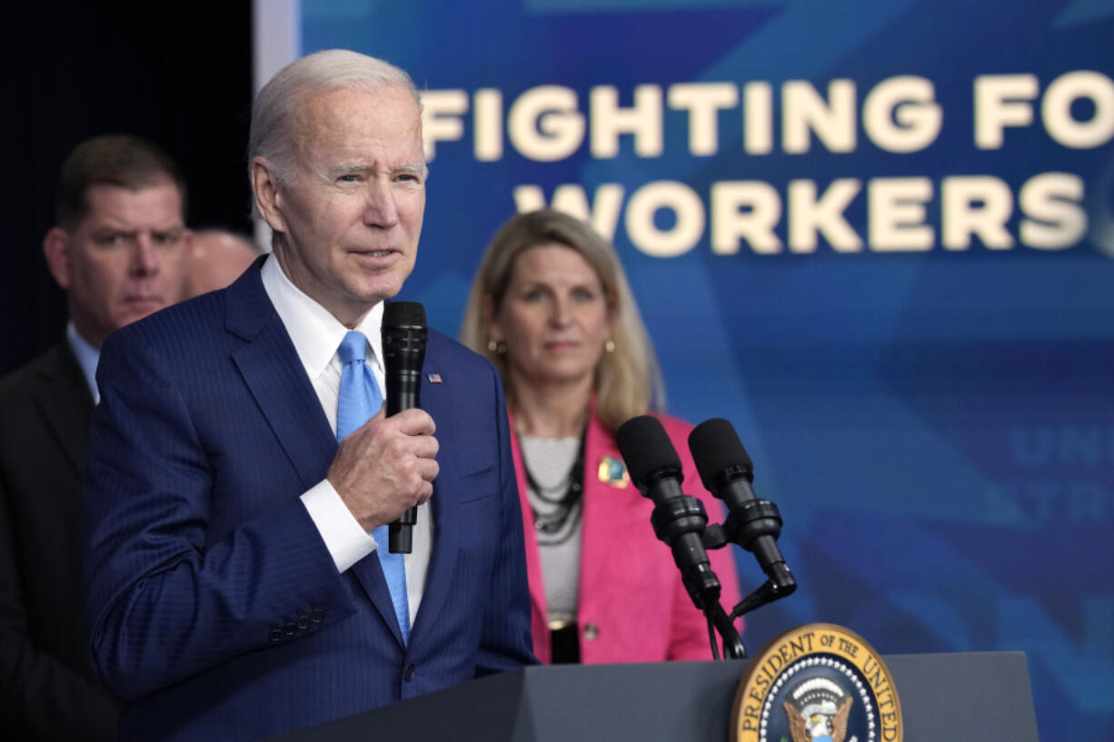 FILE - President Joe Biden speaks as AFL-CIO President Liz Shuler, right, listens, Dec. 8, 2022, in Washington. Facing pressure from within his own party to abandon his reelection campaign, Biden is relying on labor unions to help make the case that his record in office matters more than his age. Biden is set to meet Wednesday, July 10, 2024, with the executive council of the AFL-CIO, America&rsquo;s largest federation of trade unions. &ldquo;President Biden and Vice President Harris have always had workers&rsquo; backs &mdash; and we will have theirs,&rdquo; Shuler said.