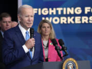 FILE - President Joe Biden speaks as AFL-CIO President Liz Shuler, right, listens, Dec. 8, 2022, in Washington. Facing pressure from within his own party to abandon his reelection campaign, Biden is relying on labor unions to help make the case that his record in office matters more than his age. Biden is set to meet Wednesday, July 10, 2024, with the executive council of the AFL-CIO, America&rsquo;s largest federation of trade unions. &ldquo;President Biden and Vice President Harris have always had workers&rsquo; backs &mdash; and we will have theirs,&rdquo; Shuler said.
