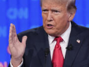 Republican presidential candidate former President Donald Trump gestures during a presidential debate with Joe Biden, Thursday, June 27, 2024, in Atlanta.