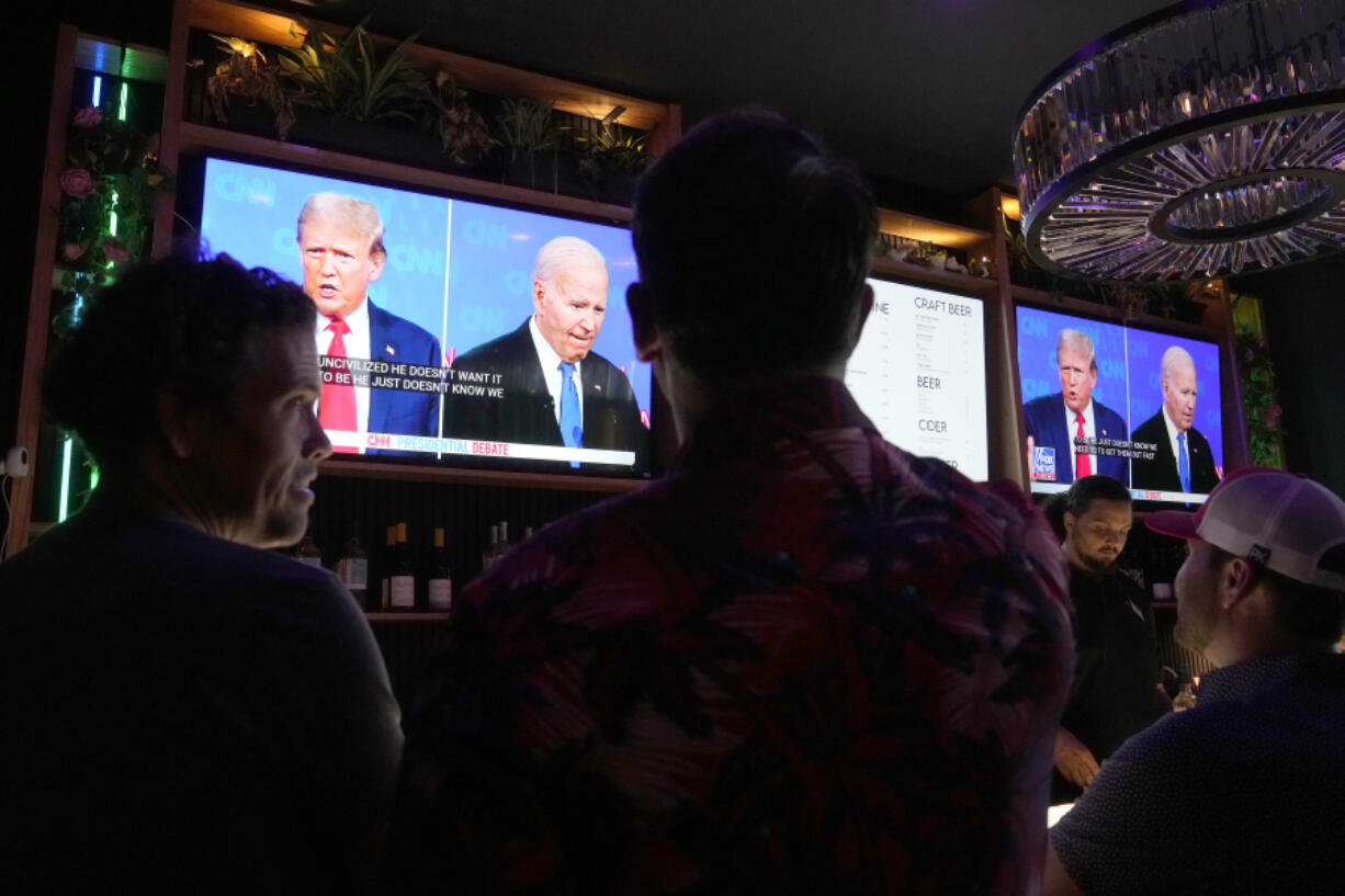 Patrons watch President Joe Biden debate Republican presidential candidate and former President Donald Trump, at a debate watch party Thursday, June 27, 2024, in Scottsdale, Ariz. (AP Photo/Ross D.