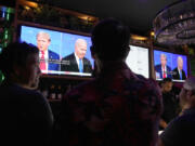 Patrons watch President Joe Biden debate Republican presidential candidate and former President Donald Trump, at a debate watch party Thursday, June 27, 2024, in Scottsdale, Ariz. (AP Photo/Ross D.