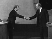 FILE - Jimmy Carter, left, and Gerald Ford, right, shake hands before the third presidential debate, Oct. 22, 1976, in Williamsburg, Va.