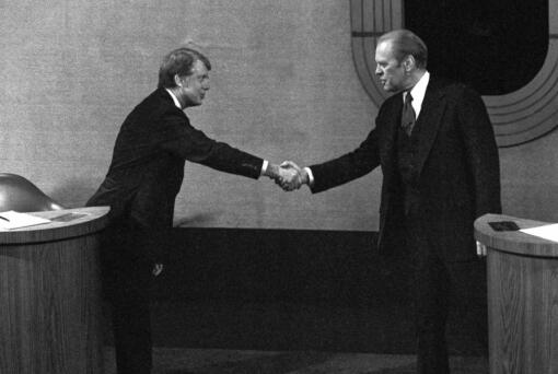FILE - Jimmy Carter, left, and Gerald Ford, right, shake hands before the third presidential debate, Oct. 22, 1976, in Williamsburg, Va.